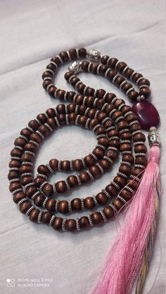 Knotted 108 Beads/ Wood,Tulsi With Stone Japa Mala Prayer Beads Hindu Krishna Mala Meditation Japa Mala Guru bead semi-precious Gemstone Round Beads // Long Tassel Necklace// Meditation japa mala // Guru bead// Necklace Yoga Beads black Color Bids size - 7mm necklace The message it emits is the strong vibration of unconditional love, joy, warmth and healing. As quartz crystals are profound amplifiers of energy, it may help to kindle happiness, love, romantic feelings and sensuality. It is good f Bohemian Mala With Large Round Beads, Pink 8mm Bohemian Beads, Brown Beaded Mala For Festivals, Festival Brown Beaded Mala, Bohemian Beaded Mala With Round Beads, Bohemian Beaded Mala, Festival Beaded Mala With Round Beads, Romantic Feelings, Yoga Beads