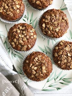 several muffins are on a plate with green leaves