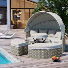 an outdoor seating area next to a swimming pool