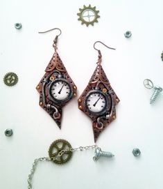 Steampunk Cooper Earrings Figured Intrigue. Unique handmade steampunk jewelry These unusual earrings will be perfect interesting detail of your look. They are made of polymer clay, glass drops, watch parts and painted with acrylic paint. All details are handcrafted. These Figured earrings are covered with gloss varnish for better protection and hanging on a cooper tone steel settings.   ♦ Size Steampunk earrings are 8.5 cm (3.4'') long including wire and 3 cm (1.3 '') wide.         Attention!                Please use this product with care, cannot go in contact with water and dissolvent.              Real colors may slightly differ from their appearance on your display, as it depends on your monitor settings and is not under my control.  Comes safety and uniquely gift wrapped! AVAILABLE f Handmade Punk Metal Earrings, Handmade Punk Drop Earrings, Handmade Steampunk Copper Jewelry, Steampunk Style Dangle Jewelry, Handmade Copper Steampunk Jewelry, Steampunk Dangle Earrings For Pierced Ears, Steampunk Metal Earrings For Gift, Steampunk Brass Jewelry For Pierced Ears, Steampunk Handmade Jewelry For Jewelry Making