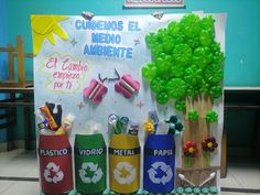 a bulletin board with several different types of items in front of it and a tree made out of plastic bottles