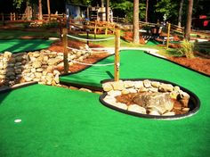 a miniature golf course with rocks and grass