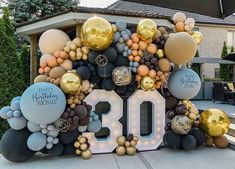 a large balloon arch with balloons on it and the number 30 in front of it