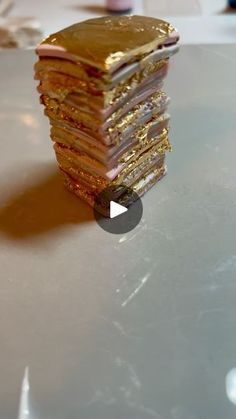 a stack of gold foil sitting on top of a table