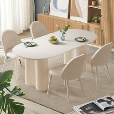 a dining room table with chairs and plates on it