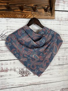 a blue bandana hanging on a wooden hanger