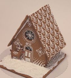 a gingerbread house with icing on the roof