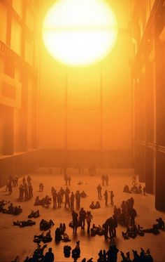 a group of people sitting on the ground in front of a sun