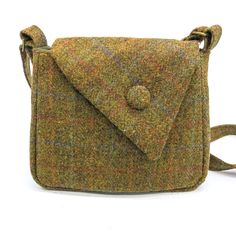 "A beautifully constructed Scottish Harris tweed® handbag with sweeping asymmetric flap. Fully lined with complementary fabric with a zipped internal pocket. The strap is adjustable to fit you perfectly. Flap is secured with a magnetic clasp and adorned with a decorative button covered in the same tweed fabric. 23 x 18 x 7cm (9 x 7 x 2 3/4\") Machine washable on a wool cycle. All items are hand wrapped in tissue paper to make a beautiful gift, but if you'd like it wrapped in special Christmas pa Scottish Tweed, Tweed Handbag, Tweed Bag, Tweed Fabric, Hand Wrap, Harris Tweed, Christmas Paper, Magnetic Clasp, Green Bag