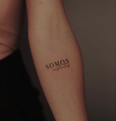 a woman's arm with the word somos written in cursive font