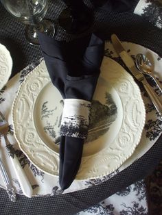 a black and white place setting on a table