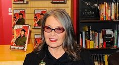 a woman standing in front of a book shelf