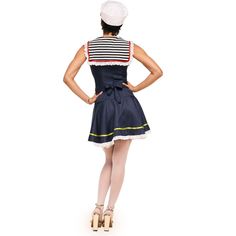 a woman in a sailor outfit is standing with her back to the camera