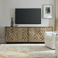 a flat screen tv mounted to the side of a wooden cabinet in a living room