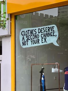 a store window with clothes on display and a sign that says clothes deserves a second chance, not your ex