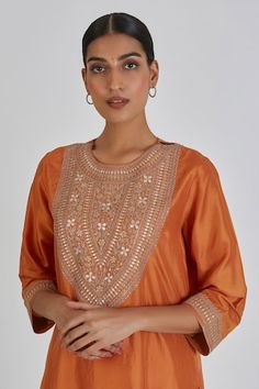 Rust orange silk kurta featuring placed zardozi floral embroidery highlighted by sequins. Comes with matching pant. - Aza Fashions Orange Embroidered Palazzo Set With Straight Kurta, Orange Silk Sets With Cutdana Details, Orange Silk Sets With Cutdana, Embroidered Orange Palazzo Set, Embroidered Orange Palazzo Set For Festivals, Orange Silk Dupatta For Reception, Traditional Orange Embroidered Palazzo Set, Traditional Embroidered Orange Palazzo Set, Orange Silk Kurta For Navratri