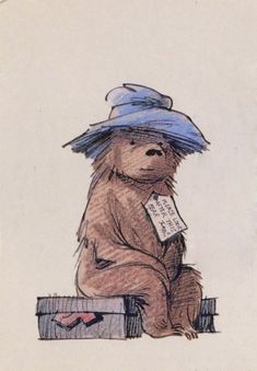 a drawing of a teddy bear with a blue hat sitting on top of a box