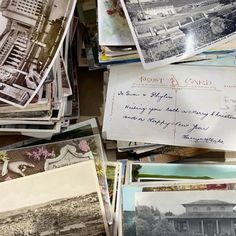 many old postcards are piled on top of each other