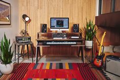 a living room filled with lots of furniture and musical equipment on top of a rug