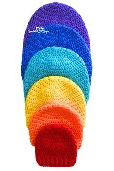 multicolored crocheted potholders are stacked together on top of each other