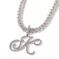 Express yourself with this icy cursive script capital initial letter pendant poised on a vibrant 9mm Cuban Link chain. This is the perfect gift for holiday, birthday, anniversary, graduation parties and more. Wear it for any occasion. Available in gold or platinum plating. 16” or 18” Cuban Link Chain with AAA Zircon Stones 18k Gold or Platinum Electroplated Brass Chain Base Metal Stones individually set with micro insert inlay technology Water and Tarnish Resistant with proper care PREORDER - Th Luxury Gold Chain Jewelry With Cubic Zirconia, Diamond Cuban Link Chain, Bling Gifts, Initial Necklace Silver, Hip Hop Bling, Cuban Link Necklace, Cursive Script, Tennis Chain, Gold Rope Chains