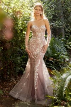 This strapless mermaid gown is a show-stopping choice for any formal event. The dress features a lace like motif made of rose tinted glass beads, exuding glamor and sparkle. The mermaid silhouette of the dress hugs the body and flares out at the knees. The back of the dress has a lace up corset, allowing for adjustable sizing and the desired hourglass shape. The dress comes with delicate matching tulle gloves, completing the look and adding a touch of sophistication fit for a queen. Gown With Gloves, Andrea And Leo, Special Ocassion Dresses, Tulle Gloves, Mermaid Sweetheart, Long Formal Gowns, Sheer Gown, Long Prom Gowns, Unique Prom Dresses