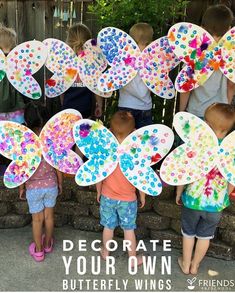 children holding up paper butterflies with the words decorate your own butterfly wings on them in front of