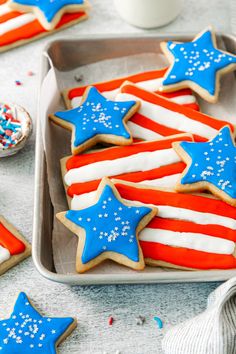 patriotic cookies decorated with royal icing and sprinkles on a baking sheet