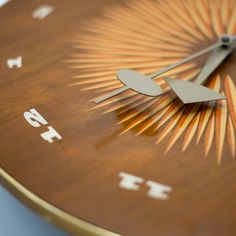 a close up of a clock with numbers on the face and an arrow in the middle