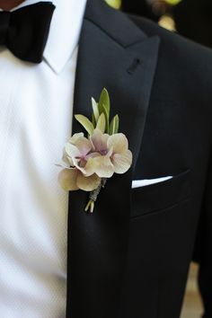 a man in a tuxedo with a flower on his lapel