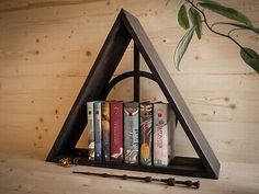 a triangle shaped shelf with books on it