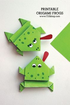 two green origami frogs sitting next to each other