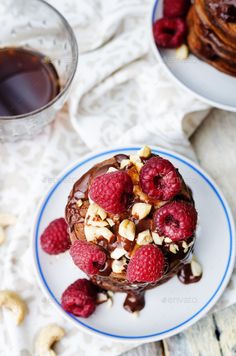 chocolate cake with raspberries and nuts on plate - stock photo - images