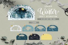 winter craft decoration with paper cut outs and scissors on the side, surrounded by foliage