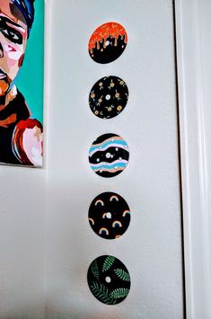 the wall is decorated with different types of buttons on it, and there are paintings above them