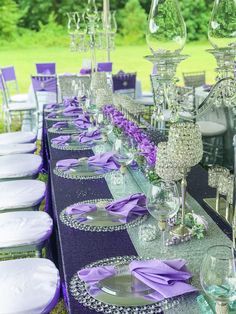 the table is set with purple and silver decorations