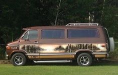 an old van is parked in the grass