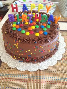 a chocolate birthday cake sitting on top of a table