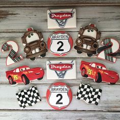 decorated cookies are arranged in the shape of cars and numbers for children's birthdays