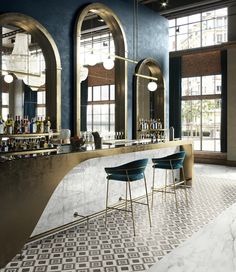 an elegant bar with marble counter tops and blue walls