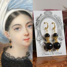 "These earrings are based off of this early 19th Century portrait I came across in my research.  Unfortunately I haven't been able to find any details about it, but it's probably from the 1820s-1830s.  Her lovely, bold black and gold earrings are so striking! My version is made with black glass beads and rich gold-plated filigree elements.  They have lots of fun dangle and movement! These measure about 2\" long, including the clasp.  Shown here on hoop findings, but also available as a leverback Victorian Baroque Earrings, Victorian Earrings For Evening, Vintage Black Earrings For Wedding, Vintage Baroque Earrings For Pierced Ears, Antique Black Drop Earrings, Antique Black Earrings For Formal Occasions, Victorian Black Earrings For Evening, Antique Black Earrings For Gift, Antique Style Black Earrings For Gift