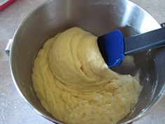 a mixing bowl filled with batter and a blue spatula