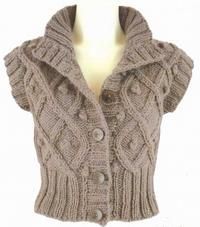 a knitted sweater vest on a mannequin torso with buttons and ruffles