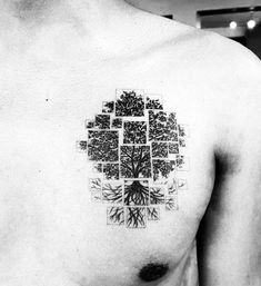 a black and white photo of a tree on the back of a man's chest