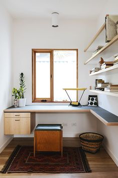 a home office with wooden shelves and white walls