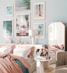 a bedroom decorated in pastel colors with pictures on the wall