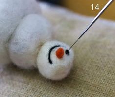 a needle is hooked to the end of a stuffed animal's nose with needles