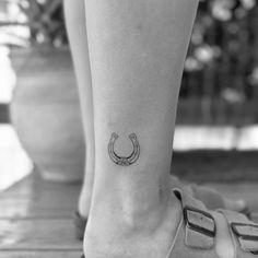 a woman's foot with a horseshoe tattoo on her left side calf tattoos, ankle tattoos, small tattoos, body art tattoos, sleeve tattoos for women, tiny tattoos