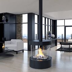 a living room filled with furniture and a fire place in the middle of it's wall