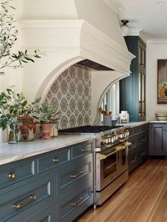 a kitchen with blue cabinets and an oven